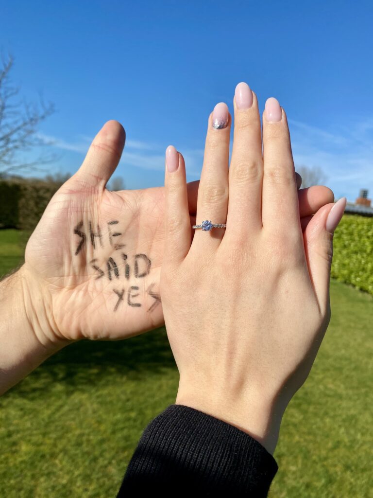 two hands together, one with a diamant ring the other with she said yes written on it | Ode2style.com