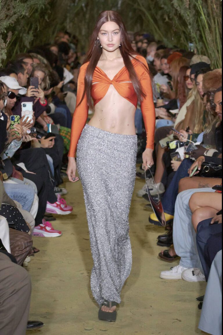 Gigi Hadid in an orange bralette and glitter skirt for Coperni spring summer 2022 | Ode2style.com