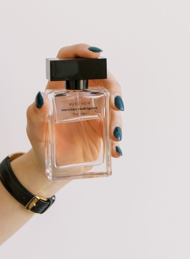 Woman holding Narciso Rodriguez Musc Noir perfume bottle | Ode2style.com