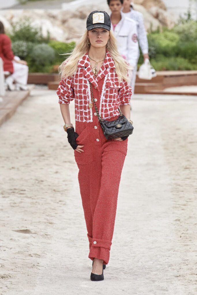 woman in a red playsuit at the Chanel cruise 2023 fashion show | Ode2style.com