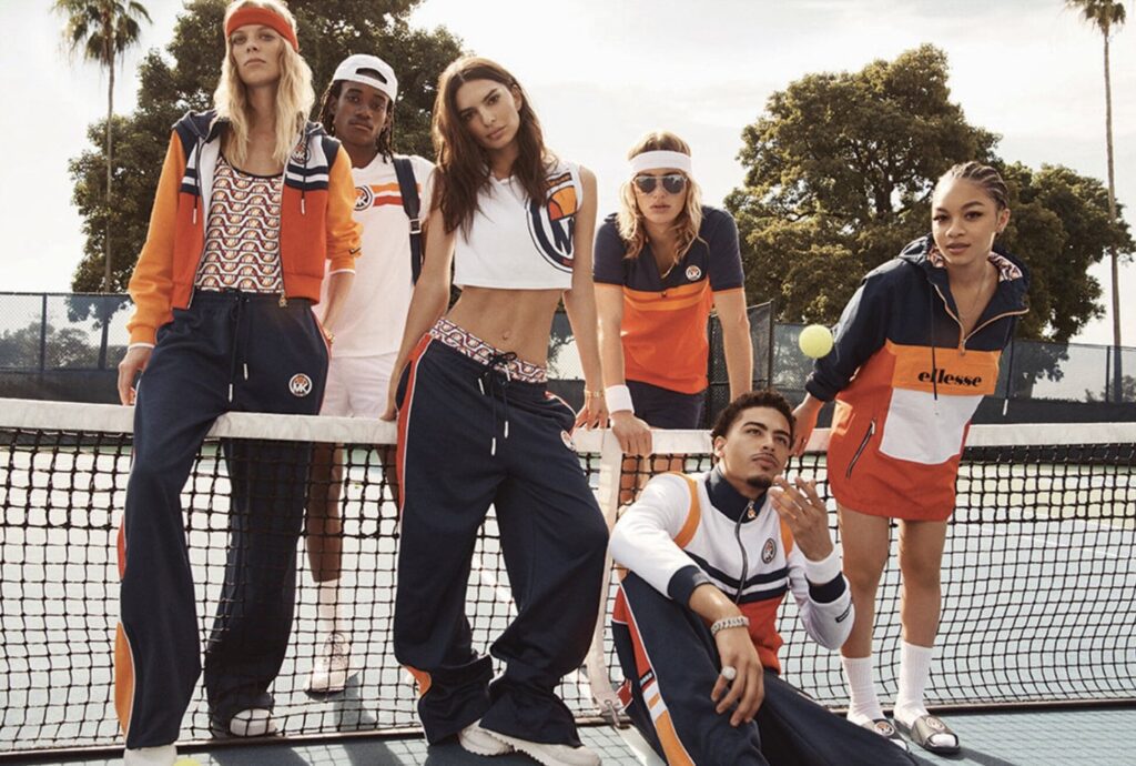 Models on a tennis court showing the Michael Kors X Ellesse collection | Ode2style.com