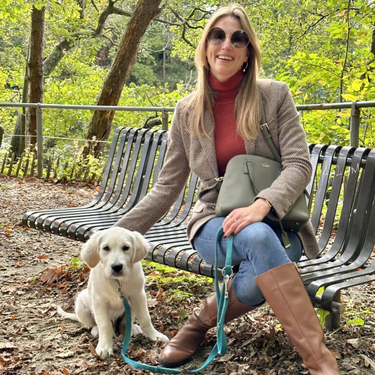 Astrid in equestrian inspired look with calf length camel boots, brown herringbone blazer on a bench in a park with a puppy | Ode2style.com