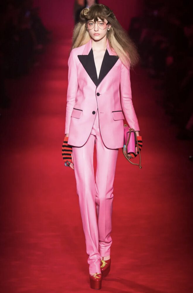 Woman wearing a pink tuxedo with a black collar designed by Alessandro Michele | Ode2style.com